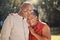 Portrait happy affectionate mature african american couple sharing an intimate moment outside at the park during summer