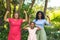 Portrait of happy african american girl with mother and granddaughter flexing muscles in backyard