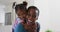 Portrait of happy african american mother and daughter hugging at home