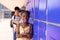 Portrait of happy african american schoolgirl standing next to locker at school