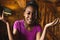 Portrait of happy african american woman spending time in log cabin and having video call