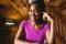 Portrait of happy african american woman spending time in log cabin and having video call