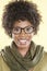 Portrait of a happy African American woman wearing glasses with a stole round her neck over colored background