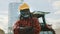 Portrait of happy african farmer in front of tractor and silo system