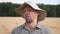 Portrait of happy agronomist making funny faces against the blurred background of wheat field. Young joyful farmer