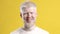 Portrait Of Happy Albino Guy Posing Over Yellow Studio Background