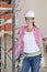 Portrait of happy architect wearing hardhat standing at construction site