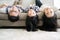 Portrait Happy Asian Family hanging upside down on sofa in living room.