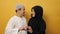 Portrait of happy Asian muslim couple shows heart shape with hands, smiling, husband and wife hugging full of love, family