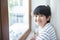 Portrait of happy asian school child boy smile in first day of back to school,Intelligent smart boy standing face to window in