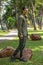 Portrait of happy asian young man in long sleeve shirt and green pant standing  in the park