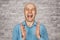 Portrait happy bald guy office worker glad to win. White bald man in blue shirt, claps hands on white brick wall background and