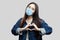 Portrait of happy beautiful brunette asian young woman with surgical medical mask in blue denim jacket standing with love heart