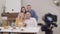 Portrait of happy beautiful family gathering and smiling at photo camera. Young redhead Caucasian man adjusting photo