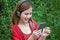 portrait of happy beautiful Young Asian women smiling in red coat listening wireless music enjoy with headphones from a smart