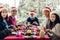 Portrait of happy big family celebrating santa hats having fun and lunch together enjoying spending time together in christmas