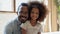 Portrait of happy biracial dad and daughter posing at home