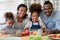 Portrait of happy biracial family with kids cook together