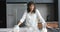 Portrait of happy biracial woman baking in kitchen, slow motion