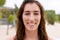 Portrait of happy biracial woman looking at camera and smiling at beach