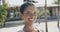 Portrait of happy biracial woman smiling on sunny beach, in slow motion