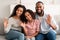 Portrait of a happy black family waving hands at camera