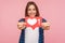 Portrait of happy blogger girl in checkered shirt smiling and showing like icon, heart button