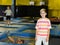 Portrait of happy boy against the background of playing children in an amusement park