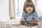 Portrait of happy boy with digital tablet lying on rug at home