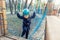 Portrait happy brave courage little toddler child boy wear safety equipment helmet enjoy passing obstacle course forest