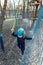 Portrait happy brave courage little toddler child boy wear safety equipment helmet enjoy passing obstacle course forest