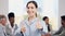 Portrait, happy and a business woman thumbs up in the boardroom with her team planning in the background. Leadership