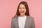 Portrait of happy carefree woman in business suit winking to camera, having playful happy expression