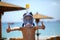 Portrait of a happy caucasian boy at the seaside wearing a diving mask and showing like gesture