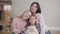 Portrait of happy caucasian brunette woman posing with two lovely daughters. Young woman, teenage girl and little pretty