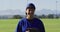 Portrait of happy caucasian female baseball player, on field smiling