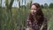 Portrait of a happy caucasian woman in the field of wheat close up