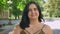 Portrait of happy charming obese woman smiling at camera and standing on street in park, cheerful and joyful