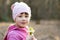 Portrait of happy child girl holding bunch of early spring snowdrops flowers outdoors