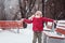 Portrait of happy child girl throwing snow on the walk in winter park