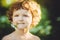 Portrait of happy child holding a daisy in his mouth. Instagram