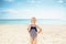 Portrait of happy child in swimsuit standing on seashore