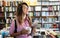 Portrait of happy college woman student at campus library