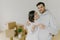 Portrait of happy couple embrace in empty room, hold keys, just arrived in own apartment, need to unpack personal belongings in