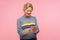 Portrait of happy cute woman with curly hair in warm sweater chatting in cellphone, reading pleasant message