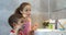 Portrait happy cute young children brushing teeth in bathroom and smiling. Children daily healthcare routine. Caucasian