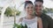 Portrait of happy diverse bride and groom smiling at sunny beach wedding, in slow motion