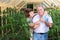 Portrait of happy elderly couple in the greenhouse