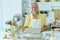 Portrait of a happy elderly man baking cookies