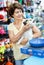 Portrait of happy elderly woman visiting pet supplies store with her cute puppy of havanese